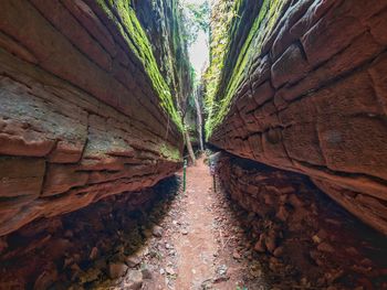 View of narrow alley amidst wall