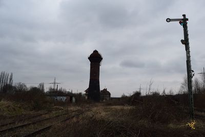 View of factory against cloudy sky