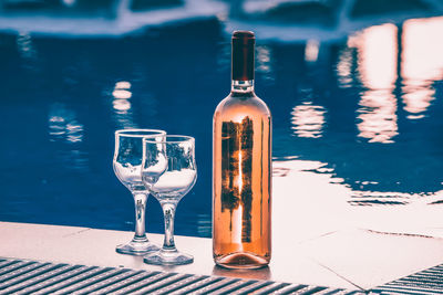 Glass of wine bottles on table