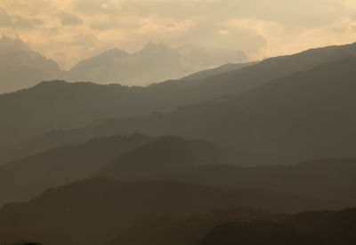 Scenic view of silhouette mountains against sky during sunset