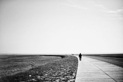 Man on shore against sky