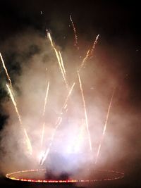 Low angle view of fireworks against sky at night