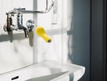 Close-up of faucet in bathroom at home