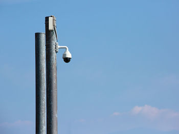 Low angle view of pole against blue sky
