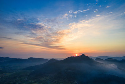 Scenic view of silhouette mountains against sky during sunset
