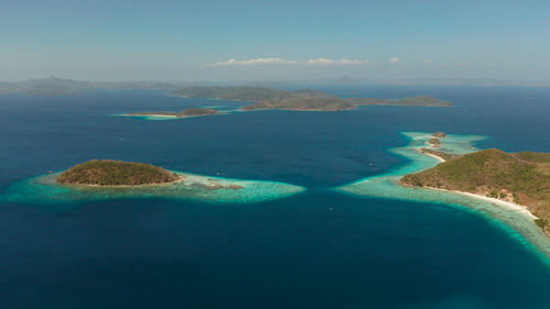 Aerial drone tropical islands with blue lagoons, coral reef and sandy beach. palawan, philippines. 