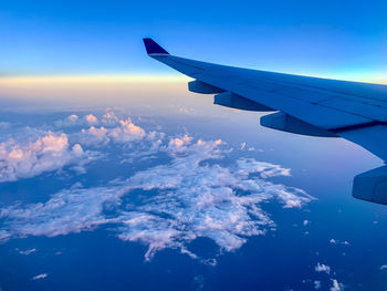 Cropped image of airplane wing against sky