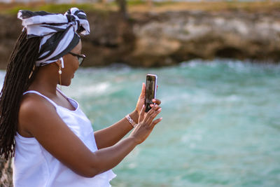 Midsection of woman using mobile phone