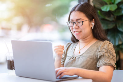 Mid adult woman using mobile phone