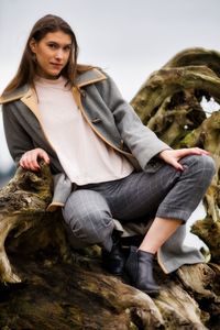 Portrait of woman sitting on rock