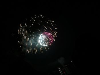 Low angle view of firework display at night