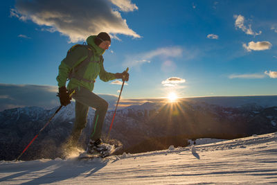 Rear view of man standing on snow