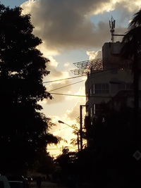 Low angle view of silhouette trees against sky