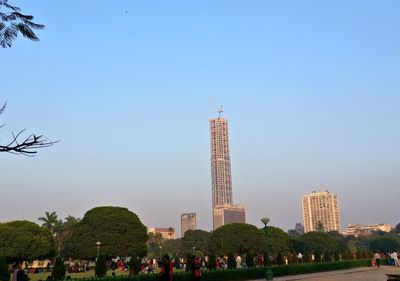 People in city against clear sky