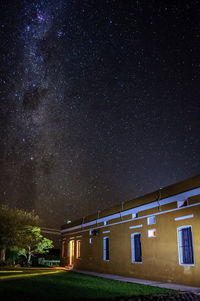 Low angle view of illuminated building against sky at night