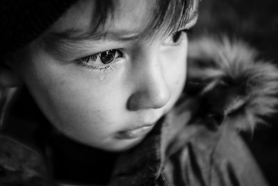 Close-up of cute boy crying while looking away