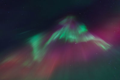 Low angle view of fireworks against sky at night