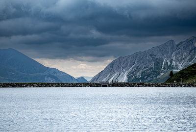 Scenic view of sea and mountains against sky