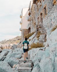 Rear view of woman on rock