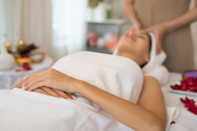 Midsection of woman lying on bed