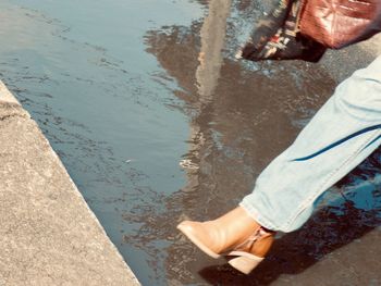 Low section of person standing on shore