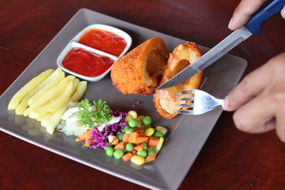 High angle view of person preparing food on table