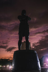 Low angle view of statue against sky at sunset