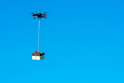 Low angle view of floodlight against clear blue sky