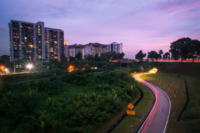 Illuminated road in city at night