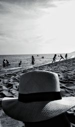 People on beach against sky