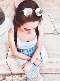 High angle portrait of woman sitting outdoors