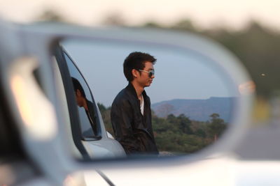 Reflection of man on mirror in car mazsa rx-8