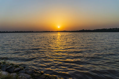 Scenic view of sea against sky during sunset