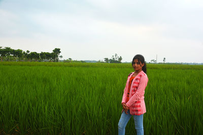 Full length of man standing on field against sky