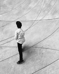 Rear view of man standing on floor