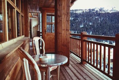 Chairs and table in building balcony during winter