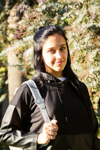 Portrait of beautiful young woman standing outdoors