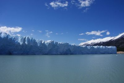 Scenic view of calm lake against mountain range