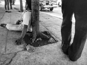 Low section of woman standing on road