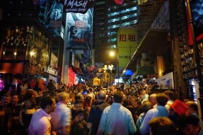 Crowd on street in city at night