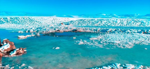Scenic view of sea against blue sky