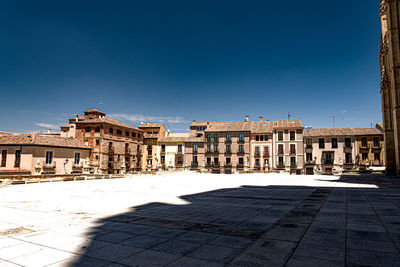 Buildings in city against blue sky