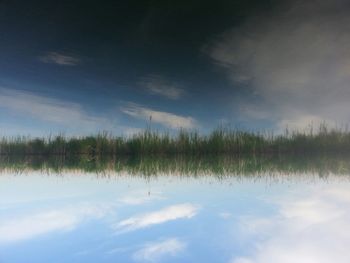 Scenic view of landscape against cloudy sky