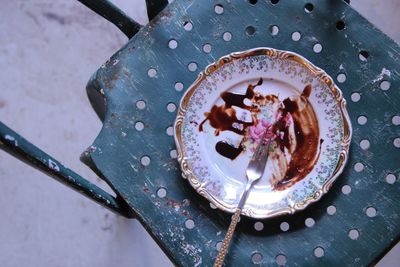 High angle view of fork and leftovers chocolate in plate on table