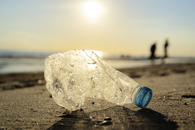 Plastic bottle on sea shore, stone ground show long life garbage concept. garbage caused 