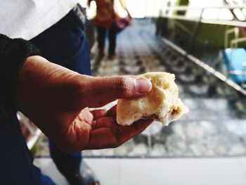 Midsection of man holding ice cream