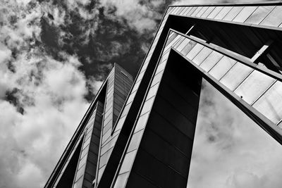 Low angle view of modern building against cloudy sky