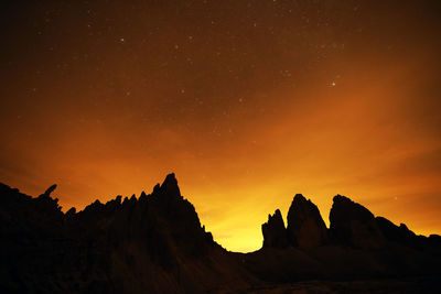 Scenic view of silhouette mountains against sky at night