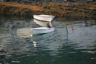 Two sailboats anchored at lake