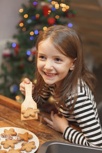 Portrait of smiling girl in christmas tree